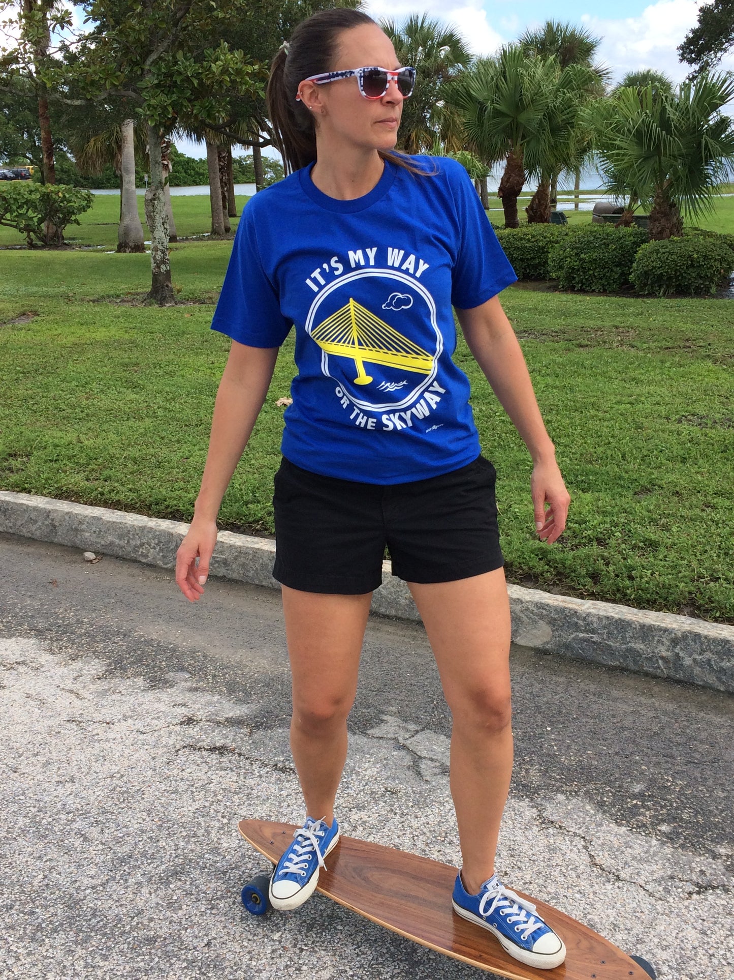 A woman on a skateboard wearing an It's My way or the Skyway t-shirt