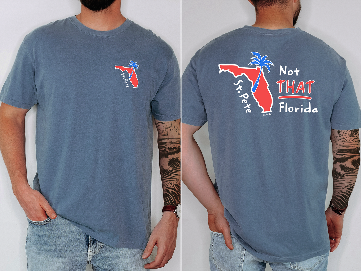 A man wearing St. Pete Not That Florida T-shirt featuring a red Florida map with a blue palm tree rising from St. Petersburg, symbolizing the city's progressive, artsy identity
