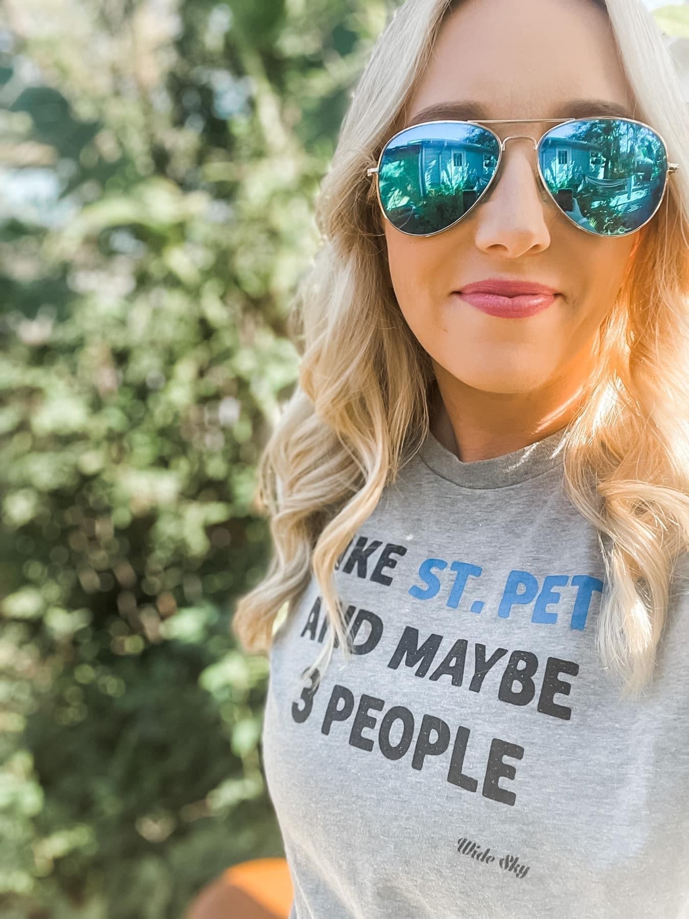 blond woman in sunglasses wearing I Like St. Pete and Maybe 3 People t-shirt on heather grey - funny Florida introvert shirt