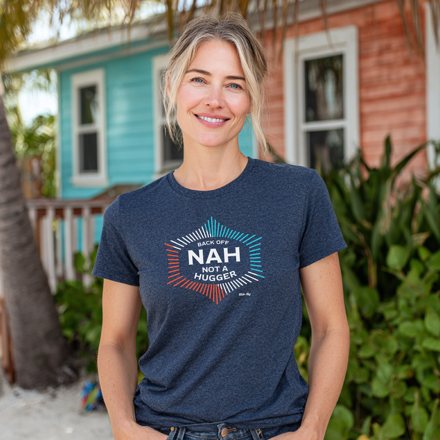 Woman standing outdoors wearing midnight navy heather t-shirt with "Not a Hugger" text in white lettering