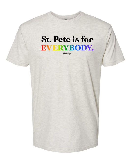Oatmeal colored t-shirt with black text reading 'St. Pete is for' with the word 'everybody' displayed in rainbow pride flag colors